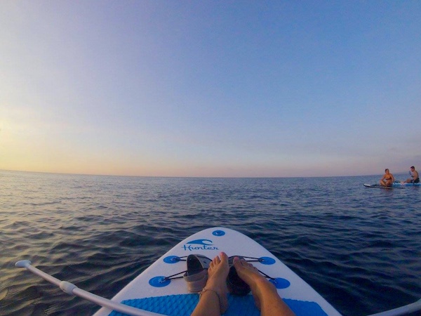 Standup paddle boarding during sunset