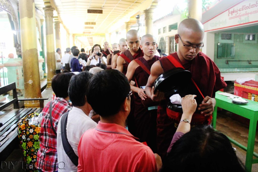 Visitors offering monks rice