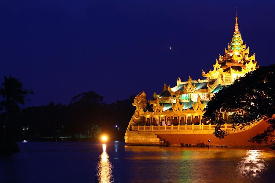 Karaweik Palace in lights on lake in Yangon