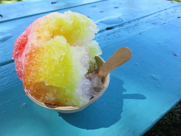 Cone of shaved ice on blue table - things to eat in Oahu